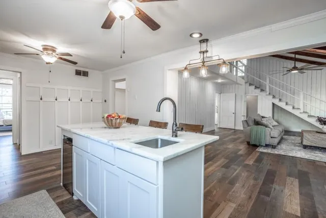 a spacious bathroom with a granite countertop sink a mirror and shower