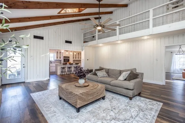 a living room with furniture and a wooden floor