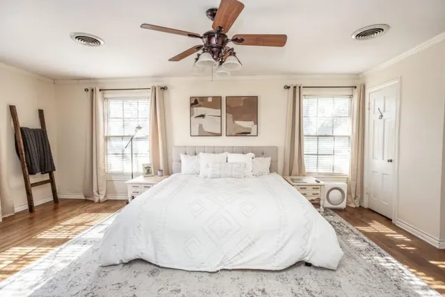 a spacious bedroom with a bed and a window