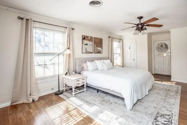 a bedroom with a bed and wooden floor