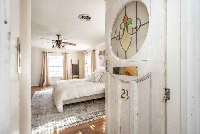 a bedroom with a bed and a chandelier
