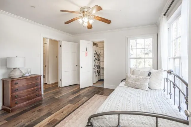 a bedroom with a large bed and a chandelier