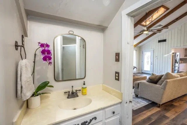 a en suite bathroom with a granite countertop tub and a sink