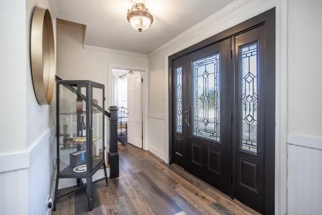 a view of a hallway with wooden floor and entryway
