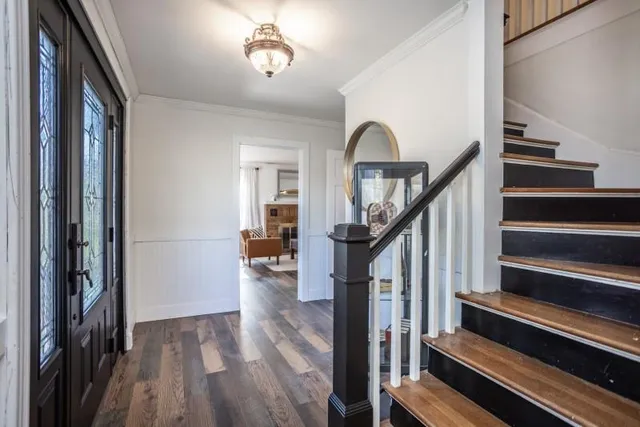 a view of entryway and hall with wooden floor