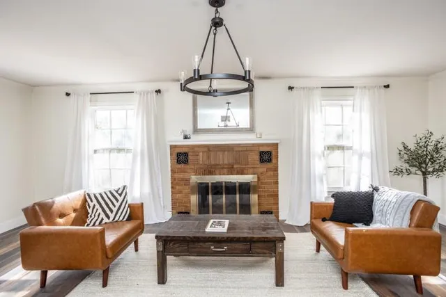 a living room with furniture and a fireplace