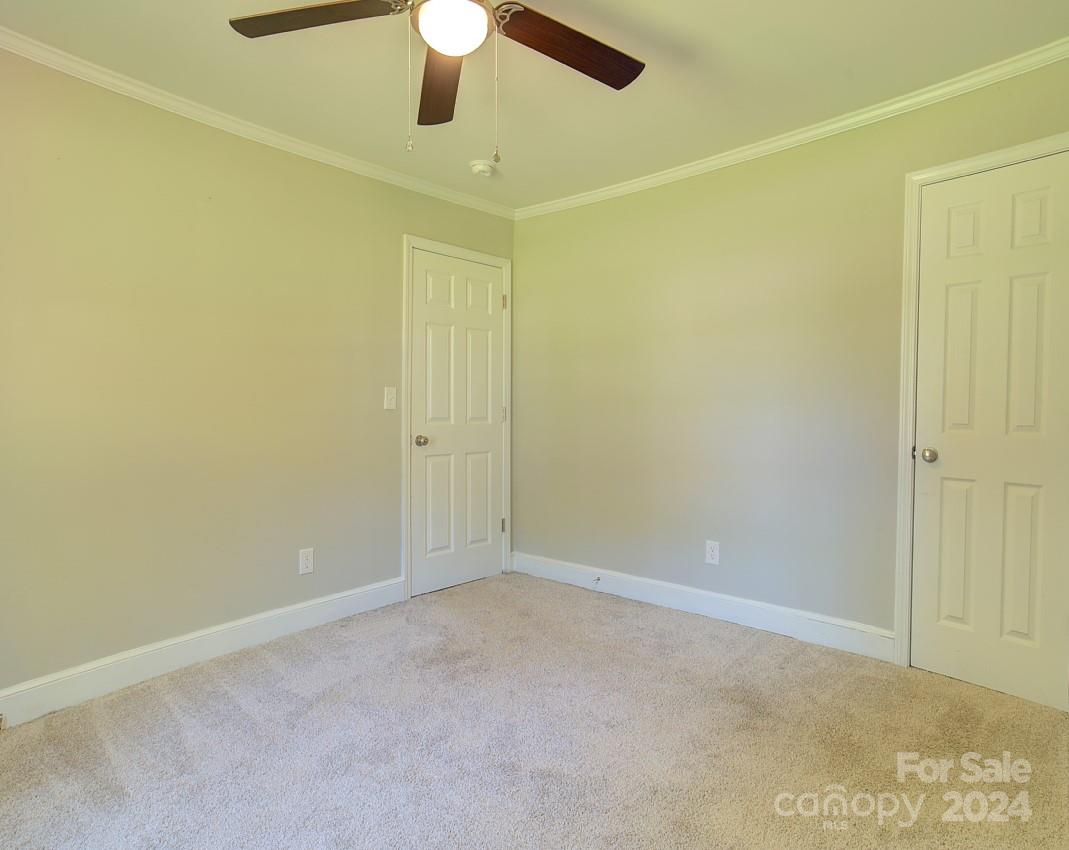 6130 Hopewell Road Hickory Grove, SC 29717 - Photo 19 of 29 an empty room with a ceiling fan and a window