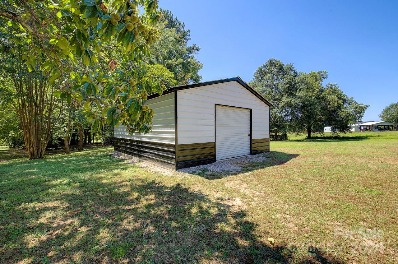 6130 Hopewell Road Hickory Grove, SC 29717 - Photo 24 of 29 a view of a house with backyard and trees