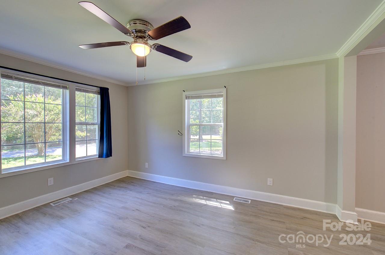 6130 Hopewell Road Hickory Grove, SC 29717 - Photo 5 of 29 a view of an empty room with wooden floor and a window