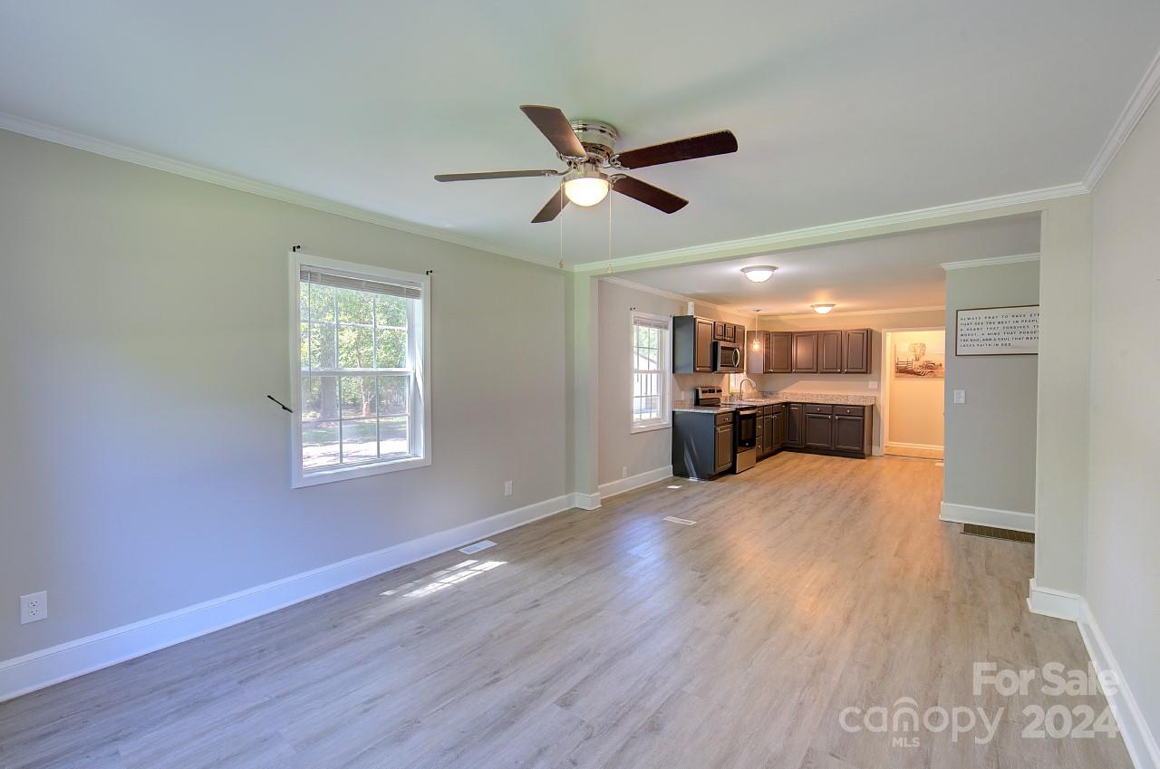 6130 Hopewell Road Hickory Grove, SC 29717 - Photo 6 of 29 a view of empty room with wooden floor and fan