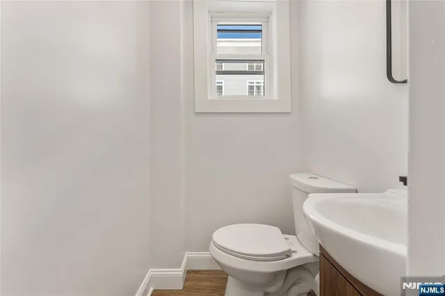 a white toilet sitting next to a white sink