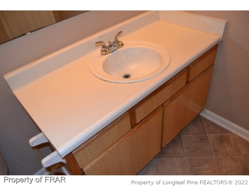 3326 Annawood Court Spring Lake, NC 28390 - Photo 11 of 19 a bathroom with a sink and a mirror