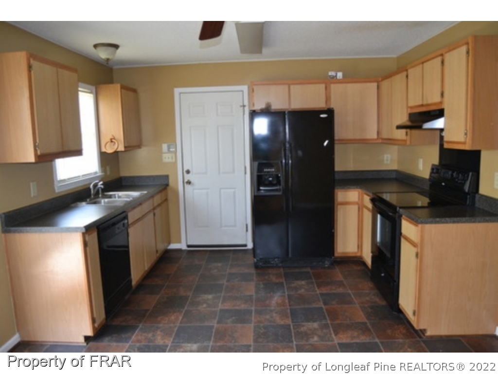 3326 Annawood Court Spring Lake, NC 28390 - Photo 6 of 19 a kitchen with a refrigerator and a stove