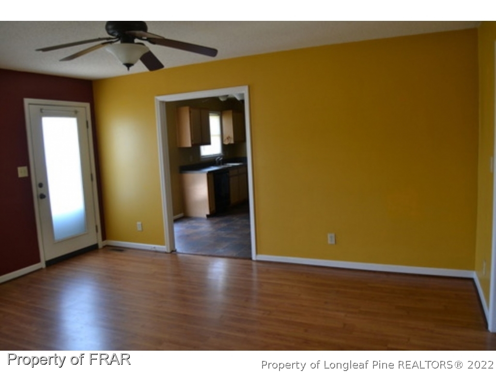 3326 Annawood Court Spring Lake, NC 28390 - Photo 8 of 19 a view of an empty room with wooden floor and a window