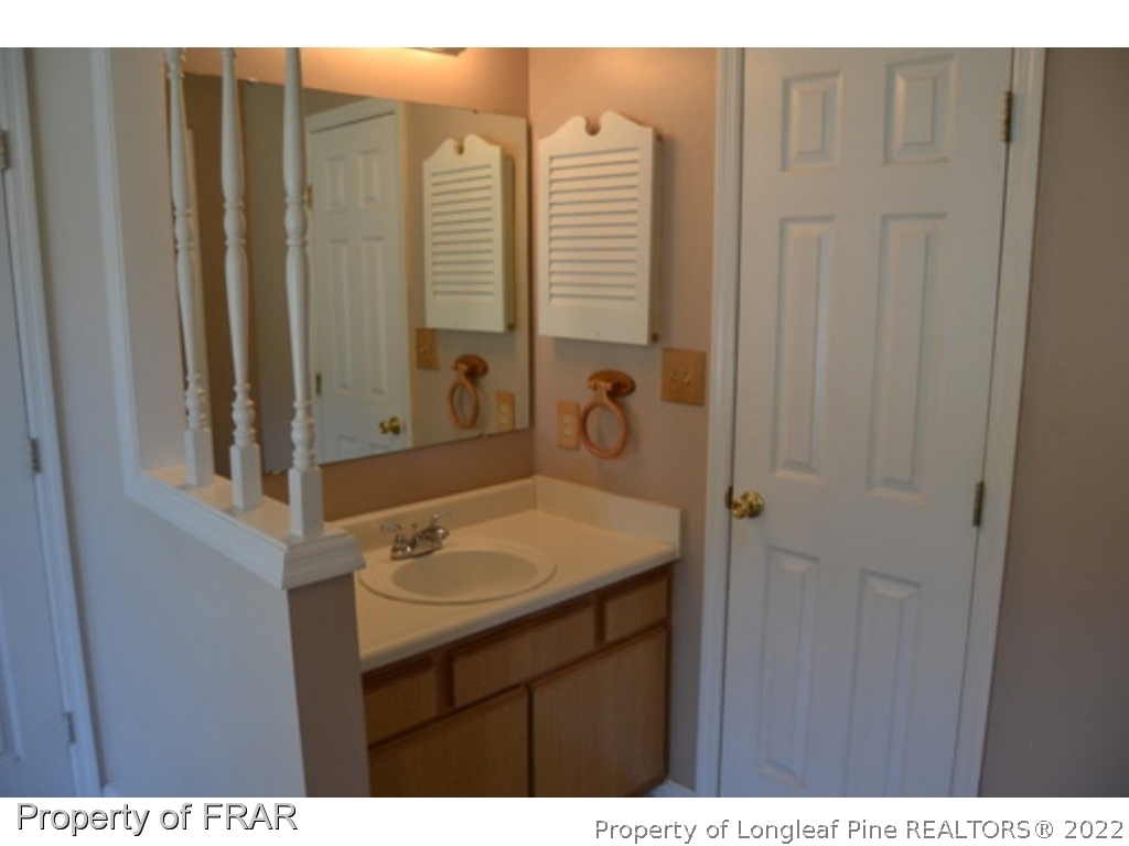 3326 Annawood Court Spring Lake, NC 28390 - Photo 10 of 19 a bathroom with a sink vanity and a mirror