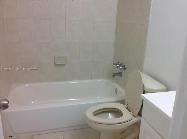 a bathroom with a sink a toilet and bathtub