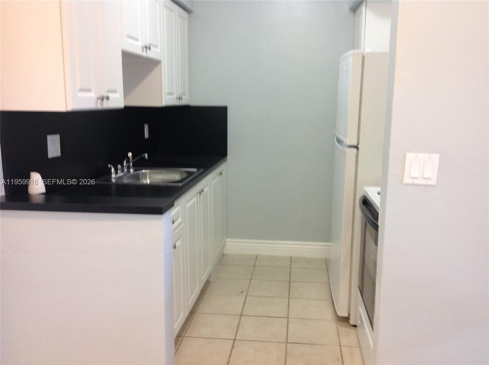 280 Southwest 11th Avenue, Unit 5 Hallandale Beach, FL 33009 - Photo 5 of 9 a bathroom with a sink and a mirror
