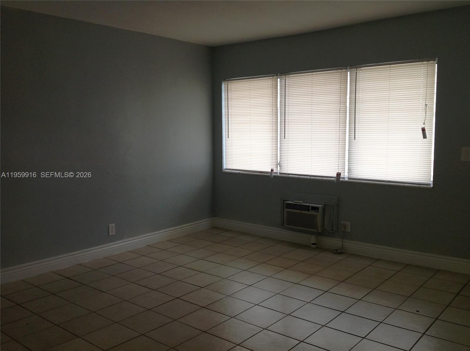 280 Southwest 11th Avenue, Unit 5 Hallandale Beach, FL 33009 - Photo 6 of 9 an empty room with windows