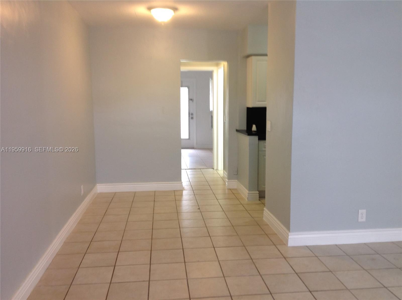 280 Southwest 11th Avenue, Unit 5 Hallandale Beach, FL 33009 - Photo 8 of 9 en empty room with wooden floor