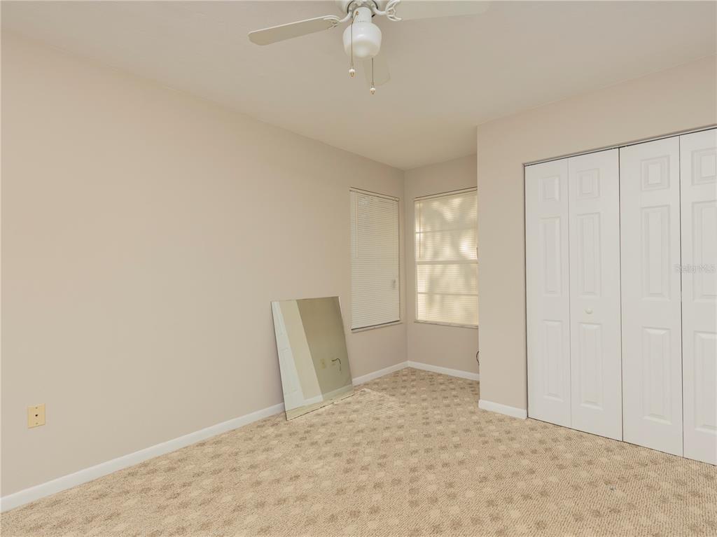 4356 Southwest 20th Lane Gainesville, FL 32607 - Photo 13 of 15 an empty room with windows and fan