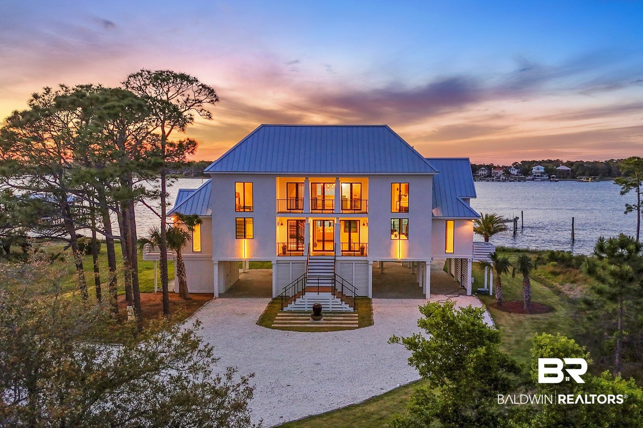 33349 River Road Orange Beach, AL 36561 - Photo 1 of 61 Waterfront residence featuring a metal roof, elevated foundation, and multiple balconies