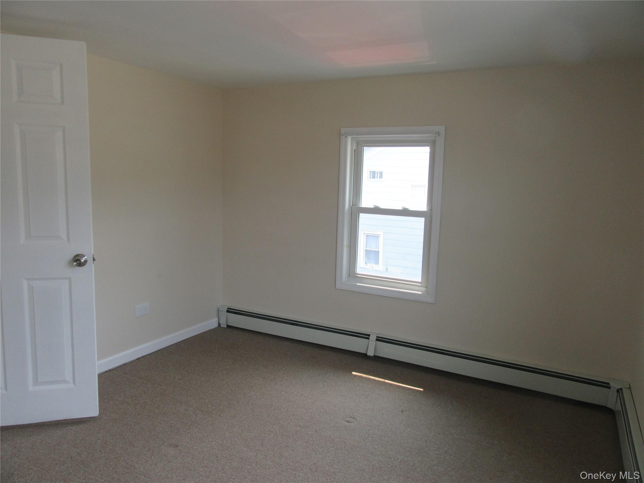 13 West Main Street, Unit 2A Washingtonville, NY 10992 - Photo 11 of 13 Carpeted spare room with a baseboard radiator