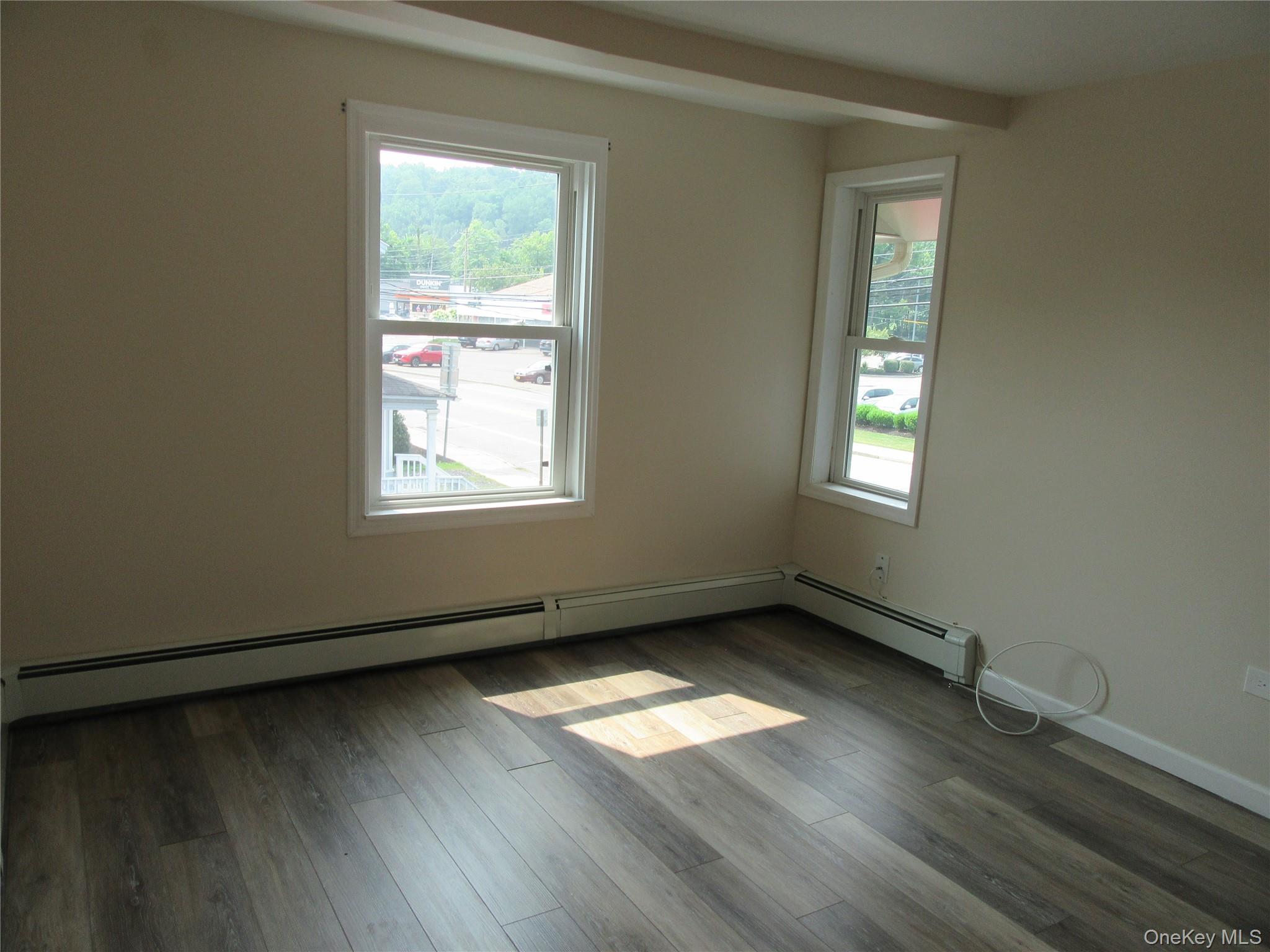 13 West Main Street, Unit 2A Washingtonville, NY 10992 - Photo 4 of 13 Spare room with a baseboard heating unit, wood finished floors, and beamed ceiling