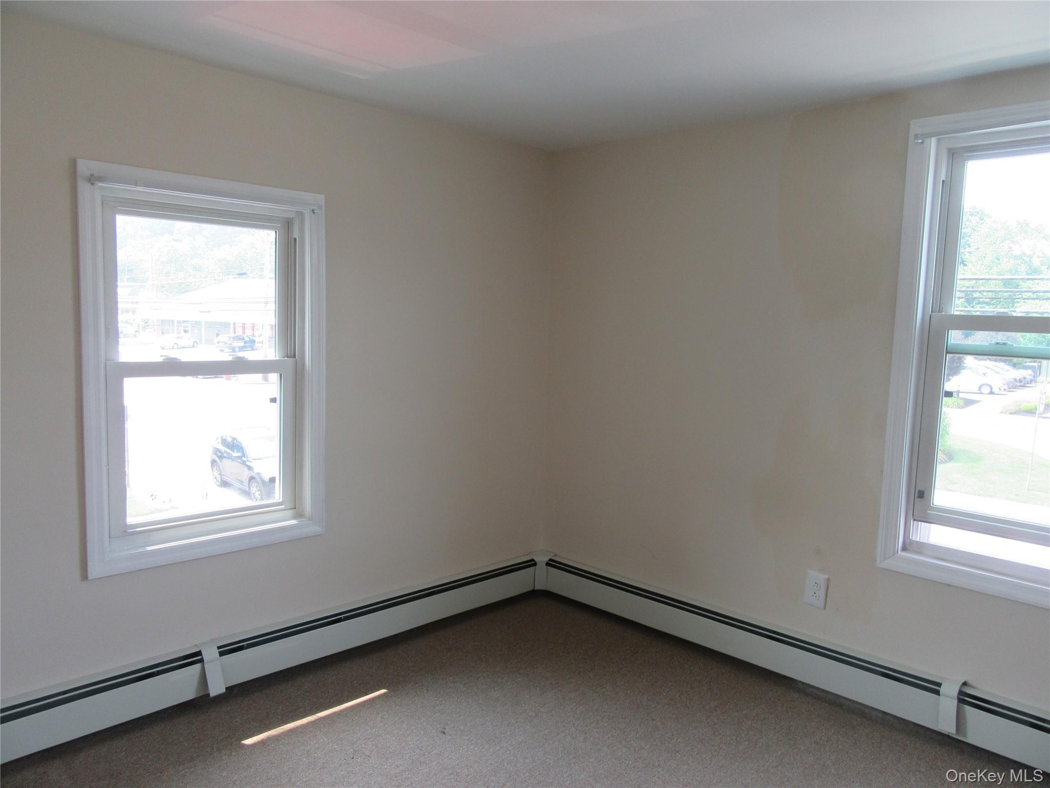 13 West Main Street, Unit 2A Washingtonville, NY 10992 - Photo 10 of 13 Unfurnished room with a baseboard heating unit and carpet flooring