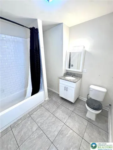 a bathroom with a sink a toilet and a shower
