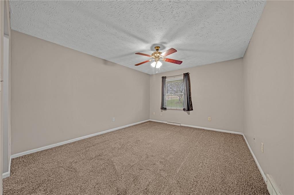 661 Georgetown Village Indiana, PA 15701 - Photo 15 of 25 an empty room with windows and chandelier fan