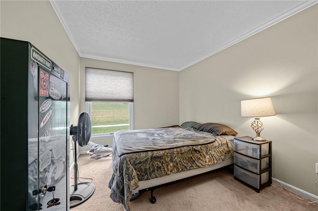 661 Georgetown Village Indiana, PA 15701 - Photo 10 of 25 a bedroom with a bed lamp on dresser and a window