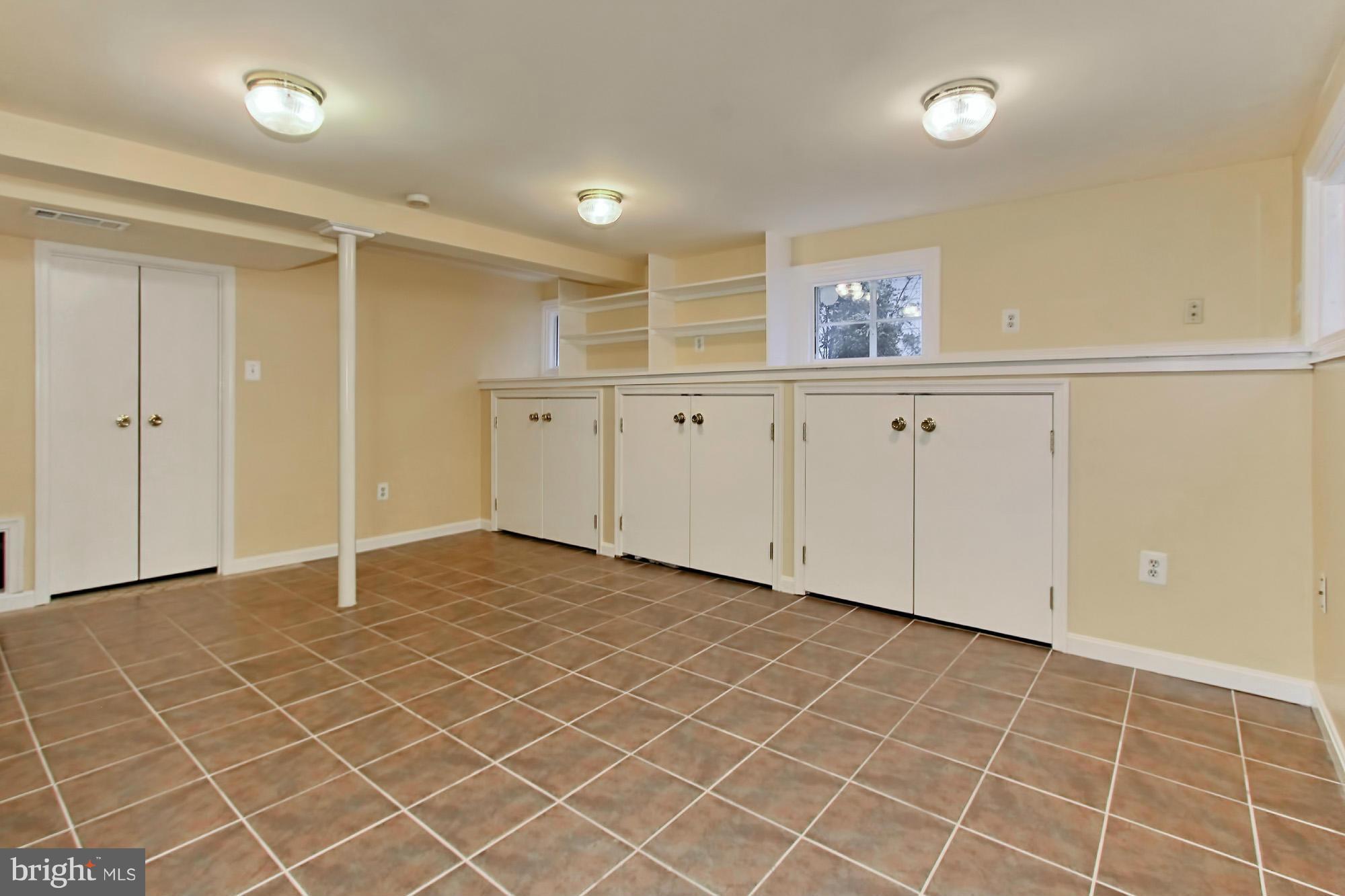 216 East Spring Street Alexandria, VA 22301 - Photo 17 of 30 Finished basement with neutral paint/design