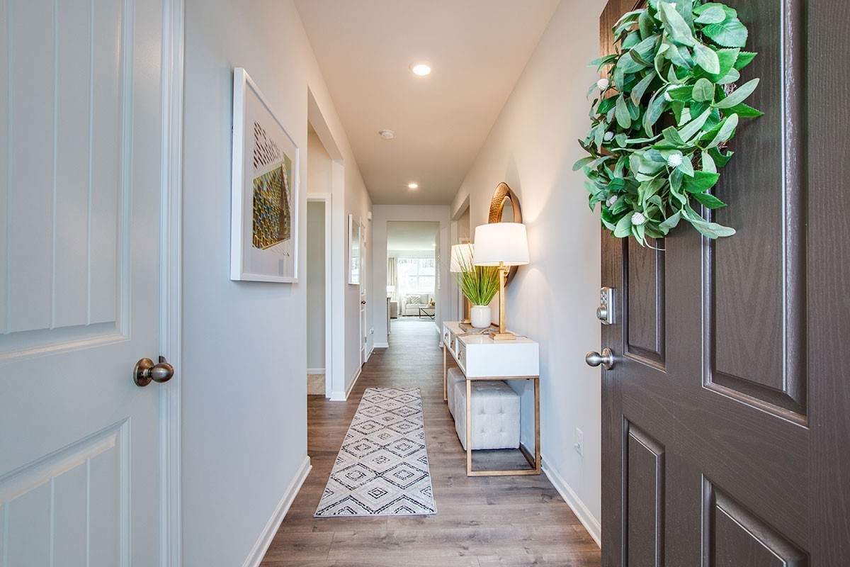 7801 Darius Circle Antioch, TN 37013 - Photo 6 of 26 a view of a hallway with wooden floor and a potted plant