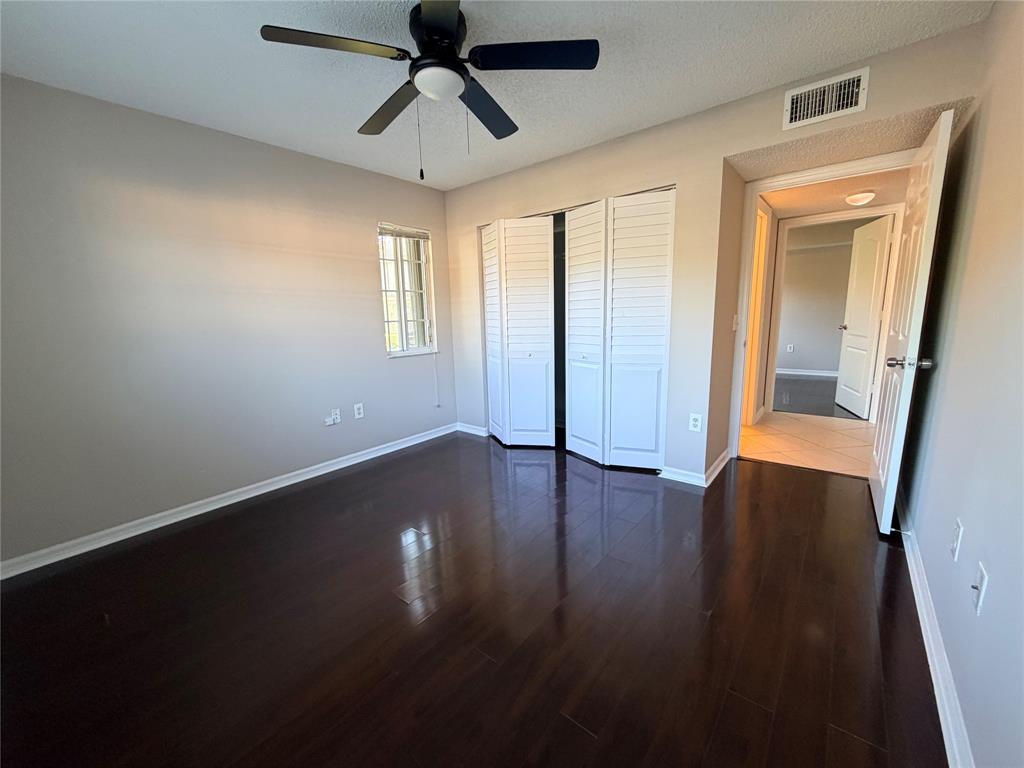 5025 Wiles Road, Unit 101 Coconut Creek, FL 33073 - Photo 15 of 27 a view of room with window and hardwood floor