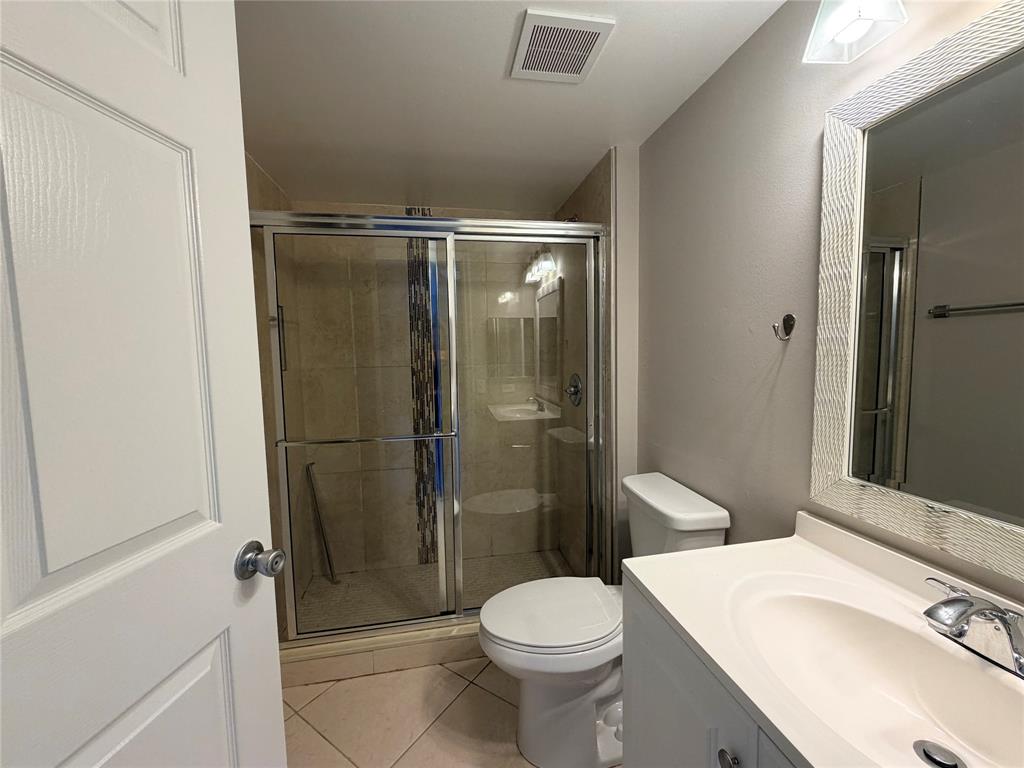 5025 Wiles Road, Unit 101 Coconut Creek, FL 33073 - Photo 21 of 27 a bathroom with a sink toilet and shower