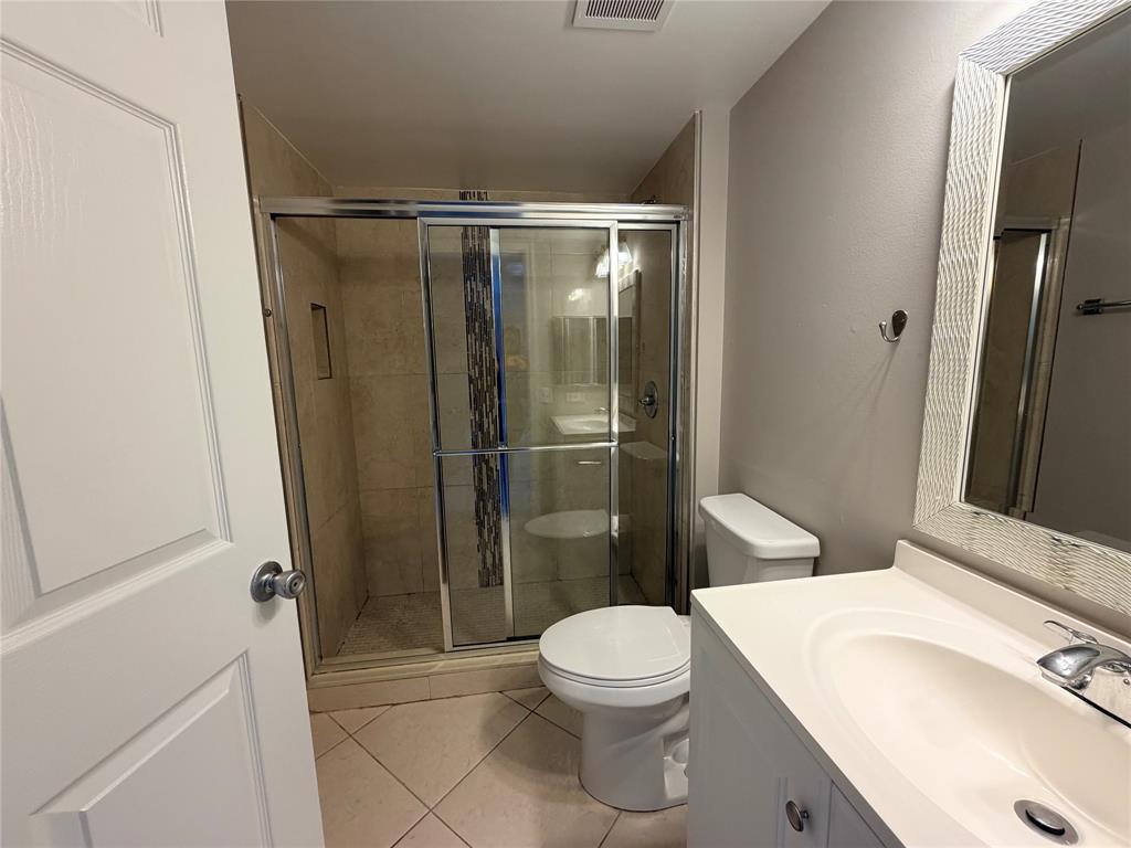 5025 Wiles Road, Unit 101 Coconut Creek, FL 33073 - Photo 22 of 27 a bathroom with a toilet a sink and shower
