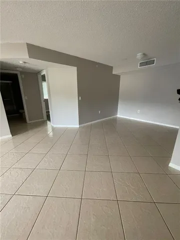 a view of an empty room with windows