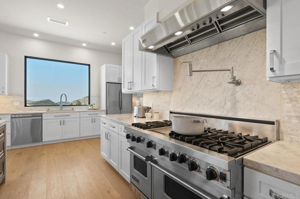 573 Lilac Ranch Road Alpine, CA 91901 - Photo 11 of 47 a kitchen with stainless steel appliances granite countertop a stove and a sink