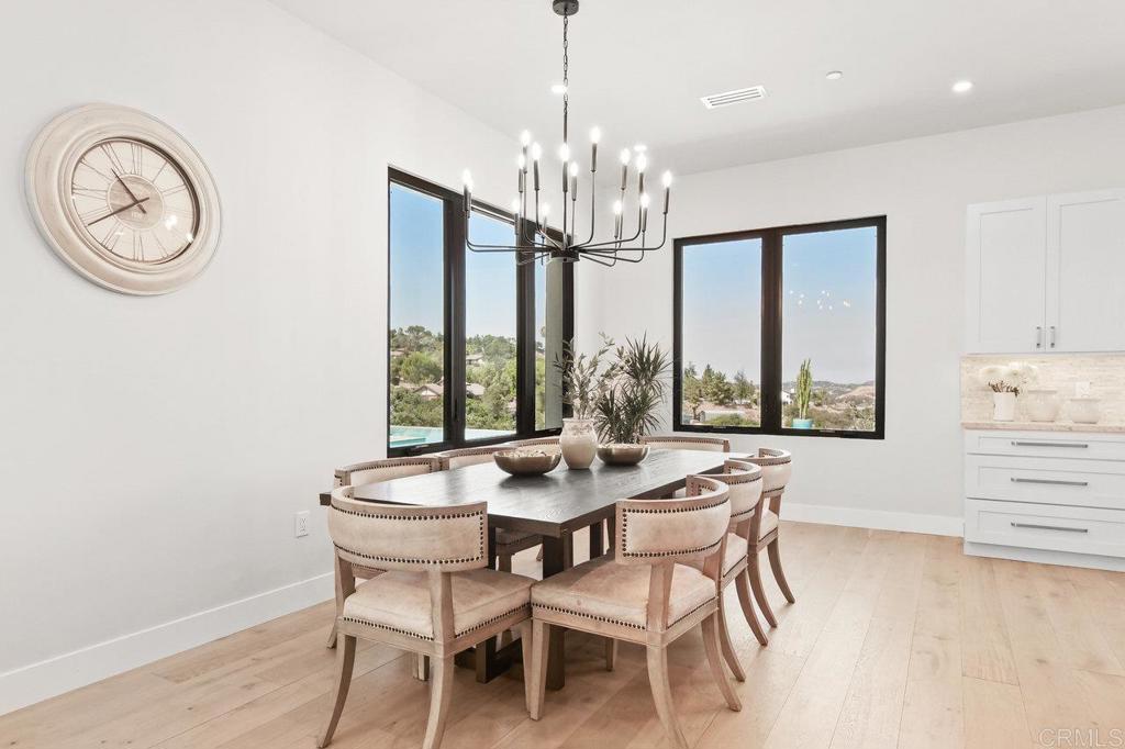 573 Lilac Ranch Road Alpine, CA 91901 - Photo 13 of 47 a dining room with chandelier a wooden table and chairs