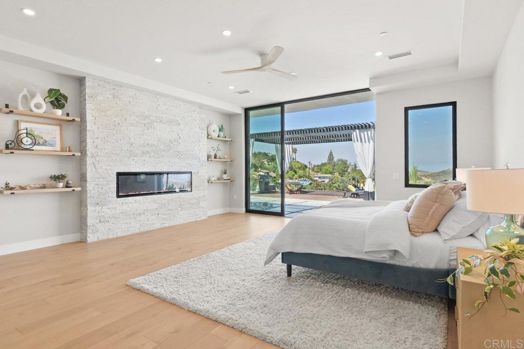 573 Lilac Ranch Road Alpine, CA 91901 - Photo 14 of 47 a spacious bedroom with a large bed and a large window