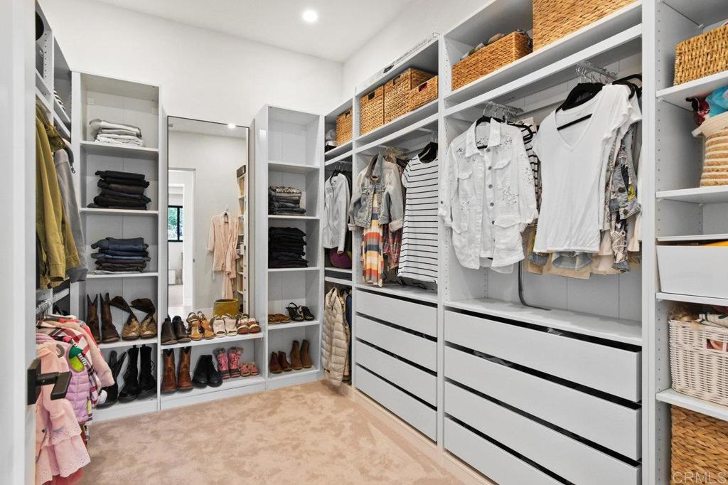 573 Lilac Ranch Road Alpine, CA 91901 - Photo 16 of 47 a view of walk in closet with clothes and shoes