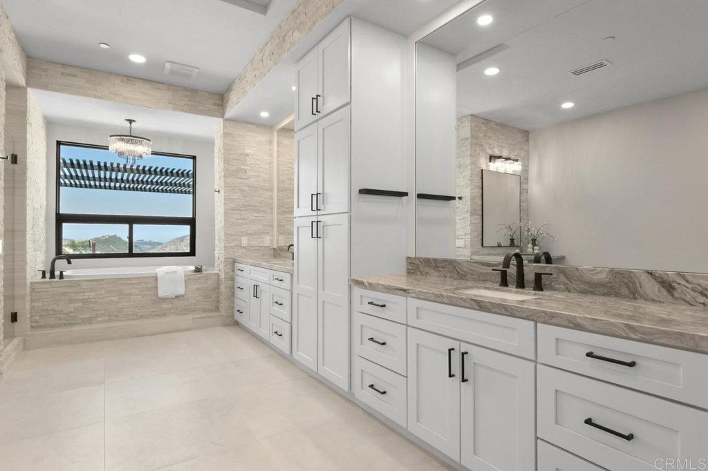 573 Lilac Ranch Road Alpine, CA 91901 - Photo 17 of 47 a bathroom with a granite countertop sink mirror and double