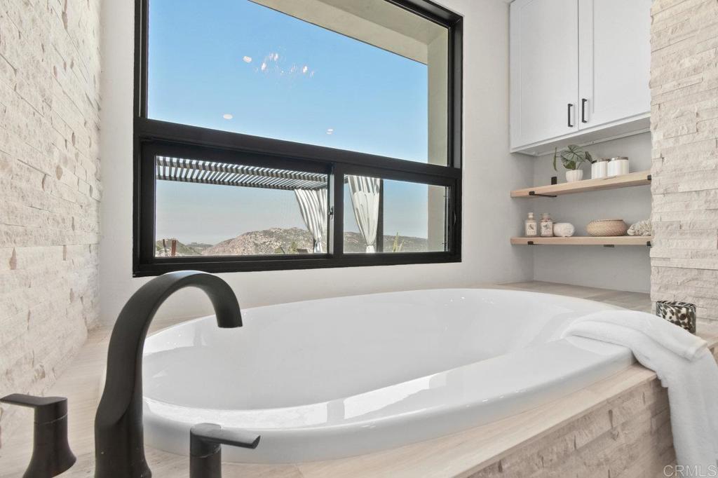 573 Lilac Ranch Road Alpine, CA 91901 - Photo 19 of 47 a bath tub sitting next to a window