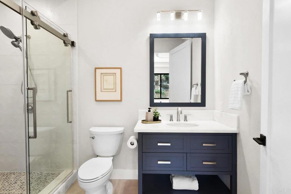 573 Lilac Ranch Road Alpine, CA 91901 - Photo 25 of 47 a bathroom with a toilet sink shower and mirror