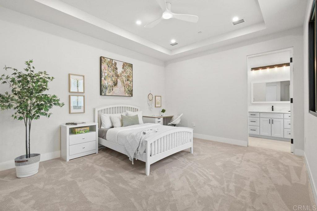 573 Lilac Ranch Road Alpine, CA 91901 - Photo 26 of 47 a spacious bedroom with a bed and a potted plant