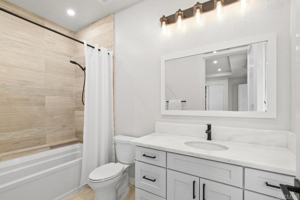 573 Lilac Ranch Road Alpine, CA 91901 - Photo 28 of 47 a bathroom with a granite countertop sink a toilet and a bathtub