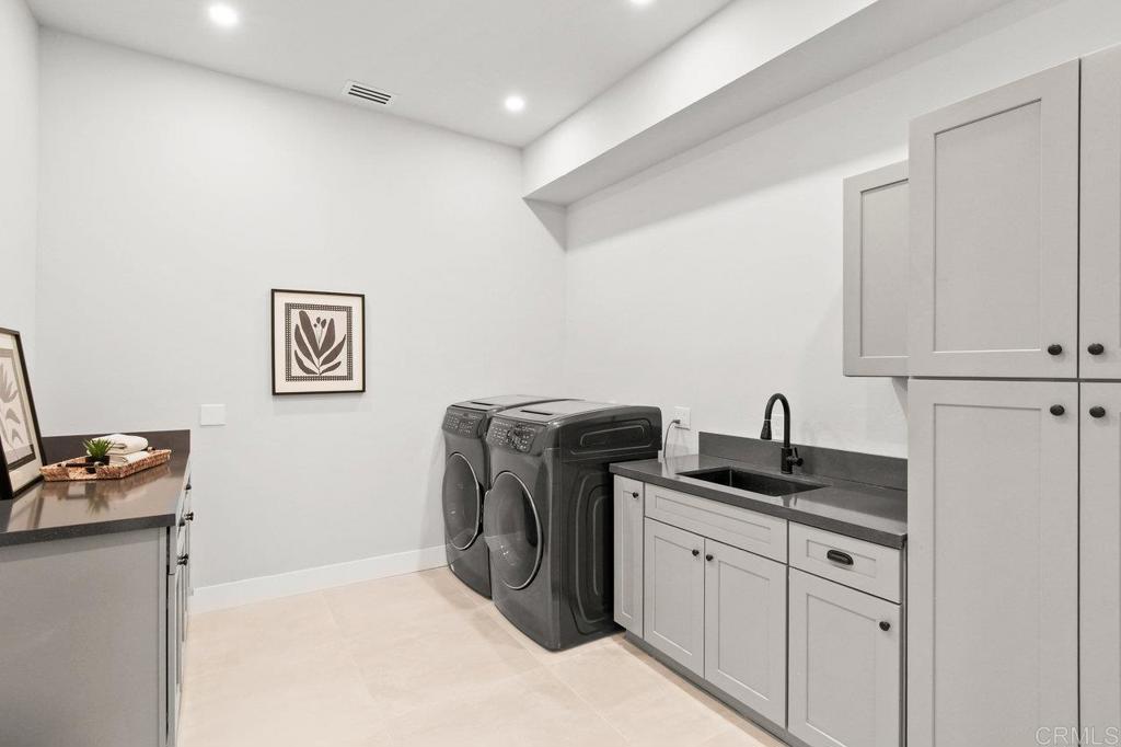 573 Lilac Ranch Road Alpine, CA 91901 - Photo 29 of 47 a kitchen with granite countertop cabinets and washer dryer