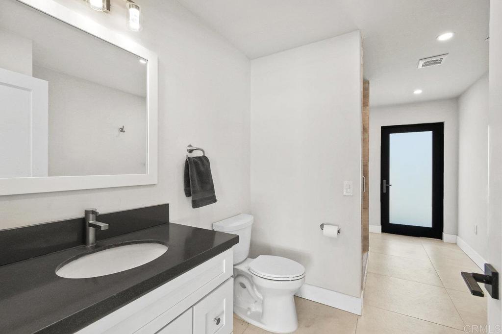 573 Lilac Ranch Road Alpine, CA 91901 - Photo 32 of 47 a bathroom with a granite countertop sink and a mirror