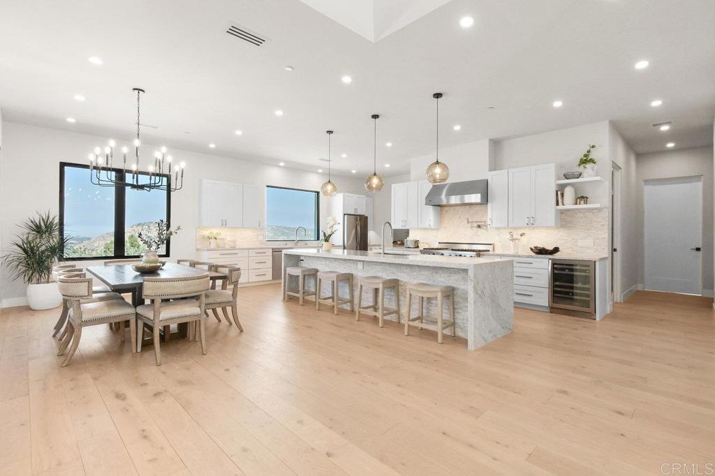 573 Lilac Ranch Road Alpine, CA 91901 - Photo 8 of 47 a kitchen with stainless steel appliances kitchen island granite top and a view of living room
