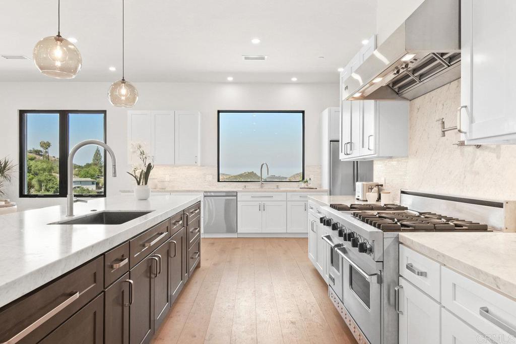 573 Lilac Ranch Road Alpine, CA 91901 - Photo 10 of 47 a kitchen with stainless steel appliances granite countertop a sink stove and cabinets
